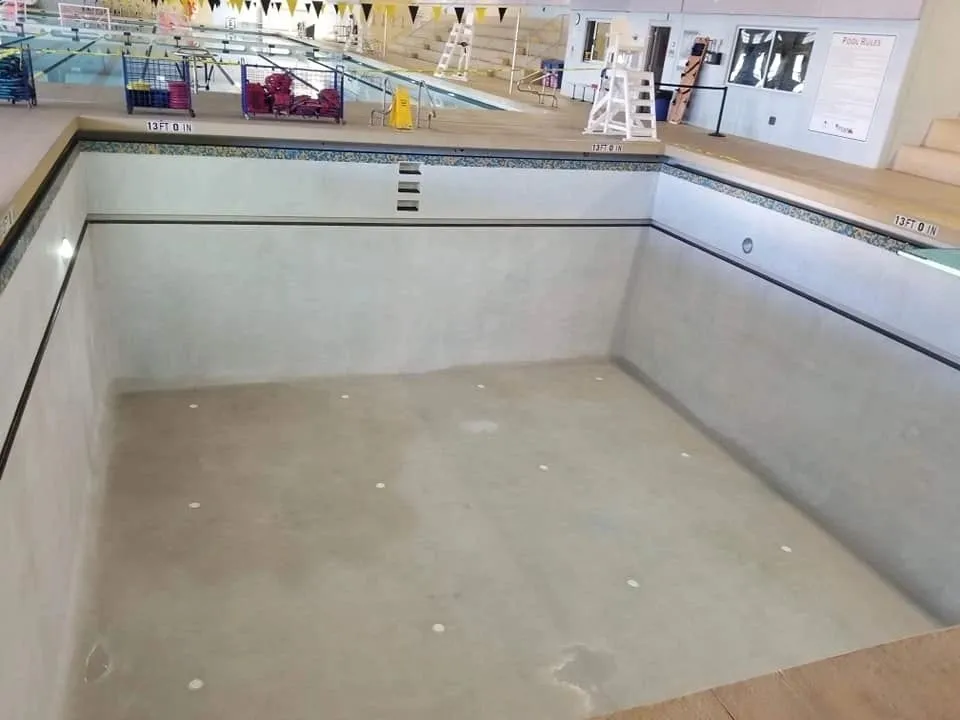 Empty indoor pool with clean surroundings and equipment.