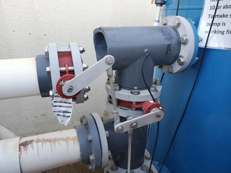 Industrial valve with a manual lever attached to piping.