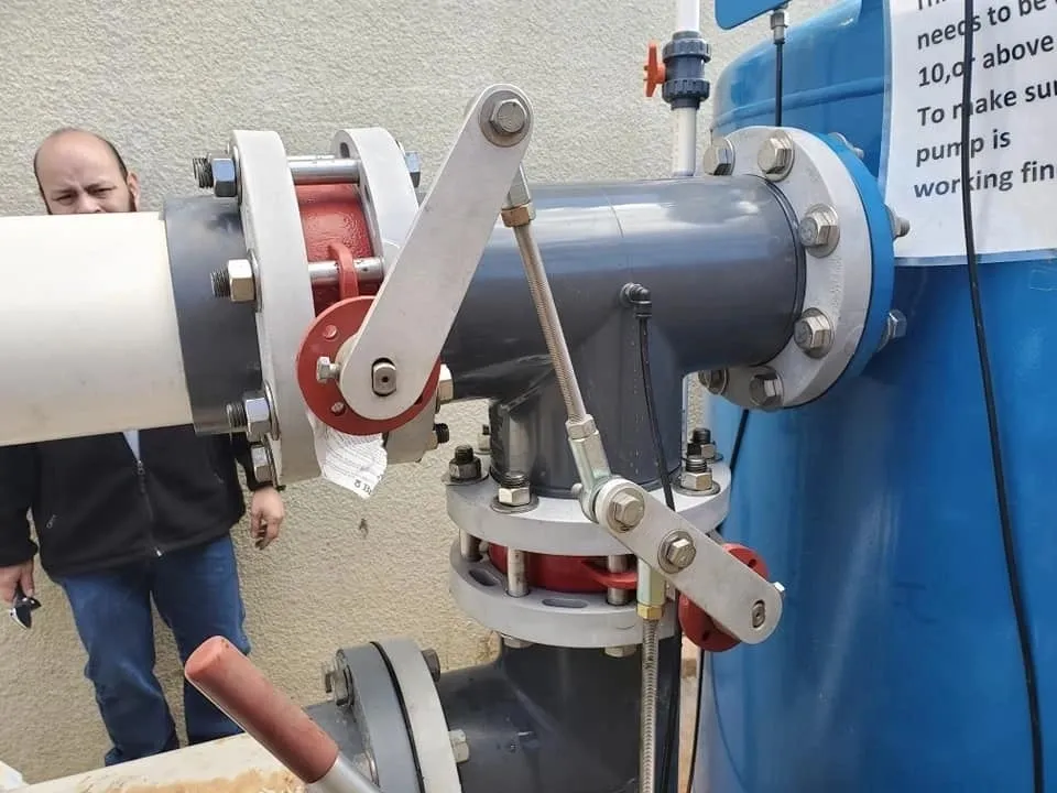 Close-up of a mechanical lever and valve system in industrial equipment.