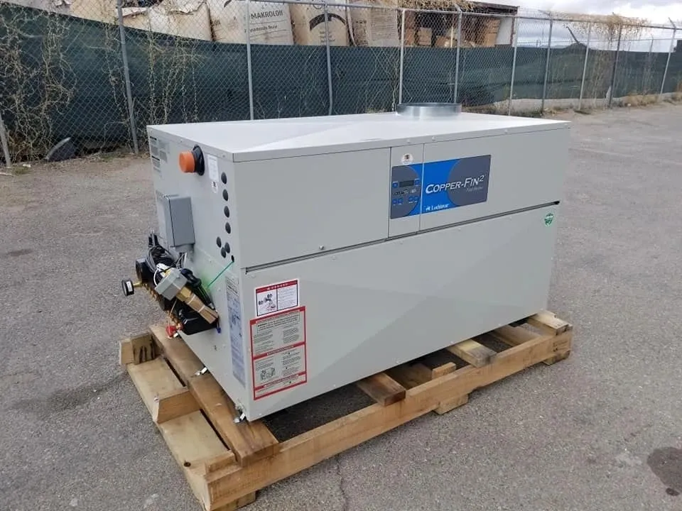 White industrial compressor unit on a wooden pallet outdoors.