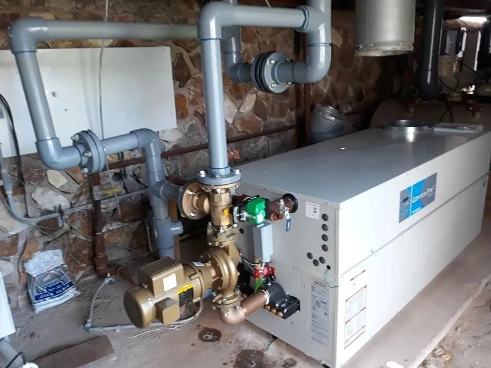 Industrial boiler system with pipes and valves.